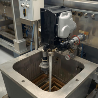Is a dosing machine better than manual dosing for grease traps?